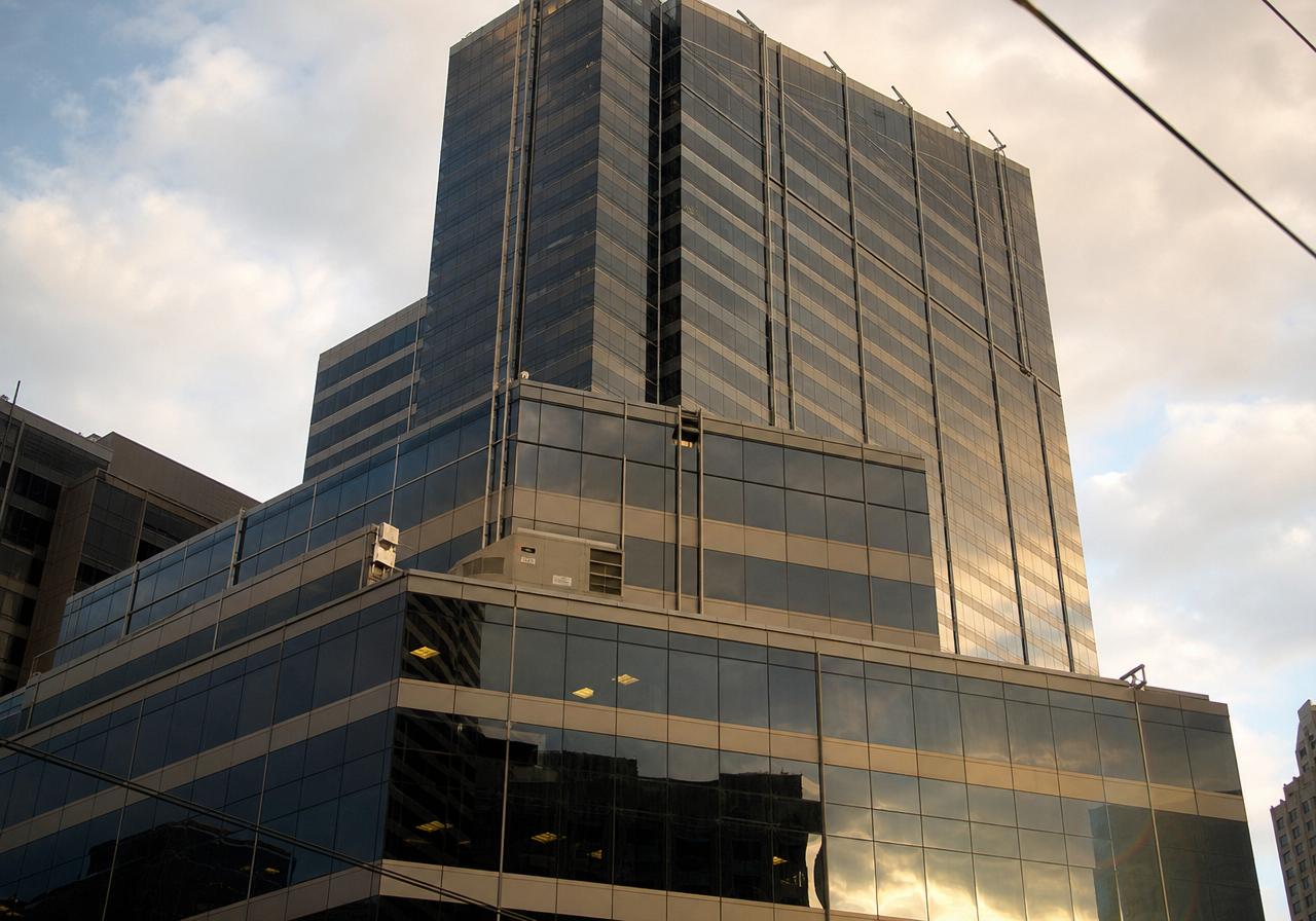 Glass corporate headquarters building at sunset